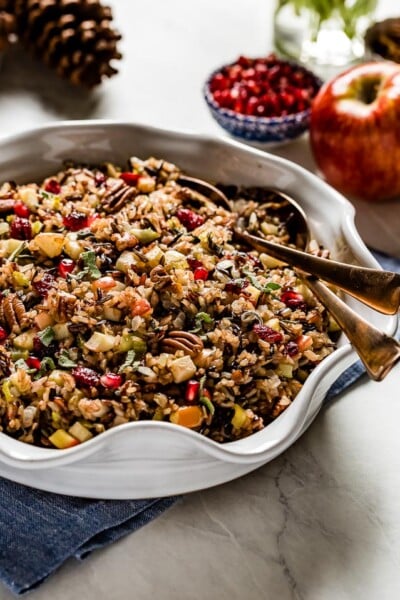 Wild Rice Stuffing in a bowl with two spoons for serving