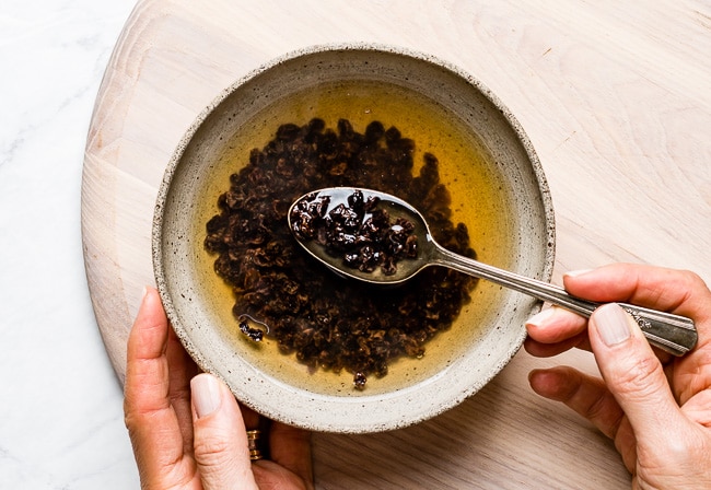 Person soaking dried currants