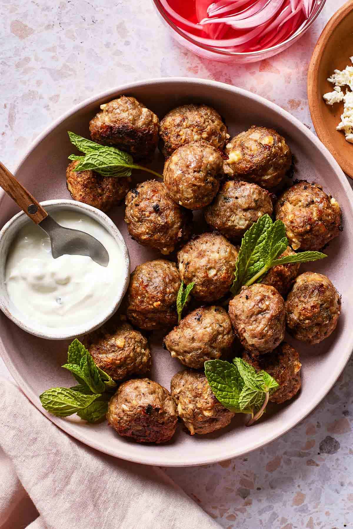 Greek lamb meatballs with yogurt mint sauce on the side.