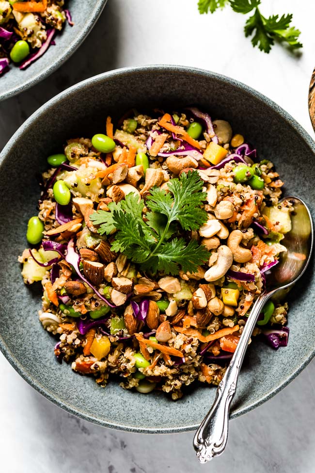 Thai Quinoa Salad in a bowl garnished with peanuts and cilantro with a spoon