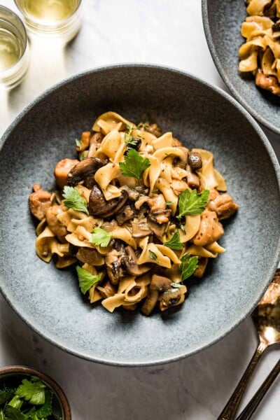Chicken Stroganoff in a bowl garnished with parsley and thyme
