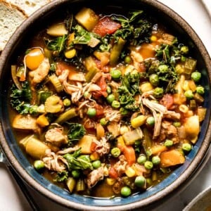 Chicken Vegetable Soup recipe placed in a bowl with bread on the side