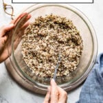 Microwave quinoa in a bowl with a person fluffing it