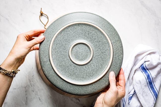 Person placing a bowl over the bowl