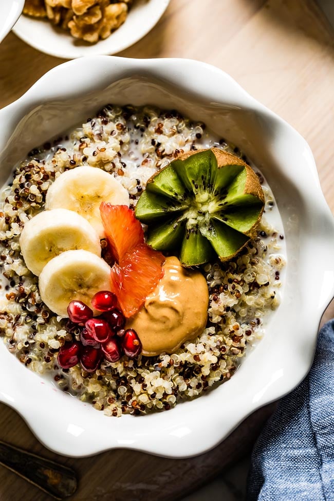 Breakfast quinoa porridge in microwave is topped off with fruit and nut butter