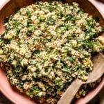 Tabbouleh Salad in a bowl with a wooden spoon on the side top view