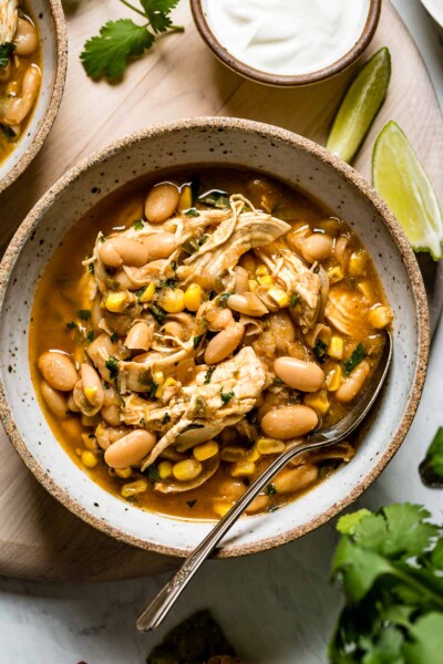 Instant Pot White bean chicken chili in a bowl with a spoon from top view