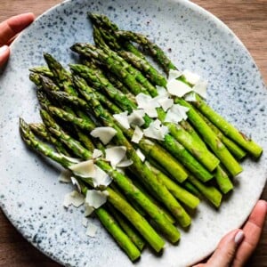 Sauteed Asparagus Recipe topped off with parmesan cheese on a plate