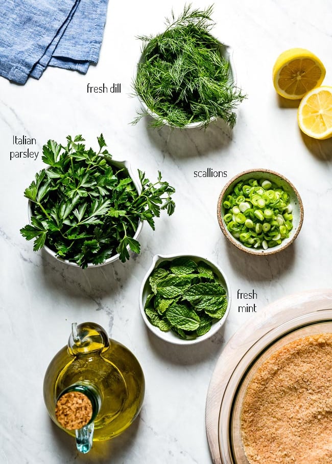 Ingredients for the salad including Fresh herbs and scallion with fresh lemon