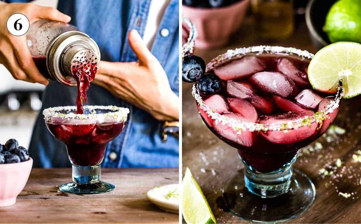 A blueberry margarita mix being strained from a cocktail shaker into a salted margarita glass filled with fresh ice.
