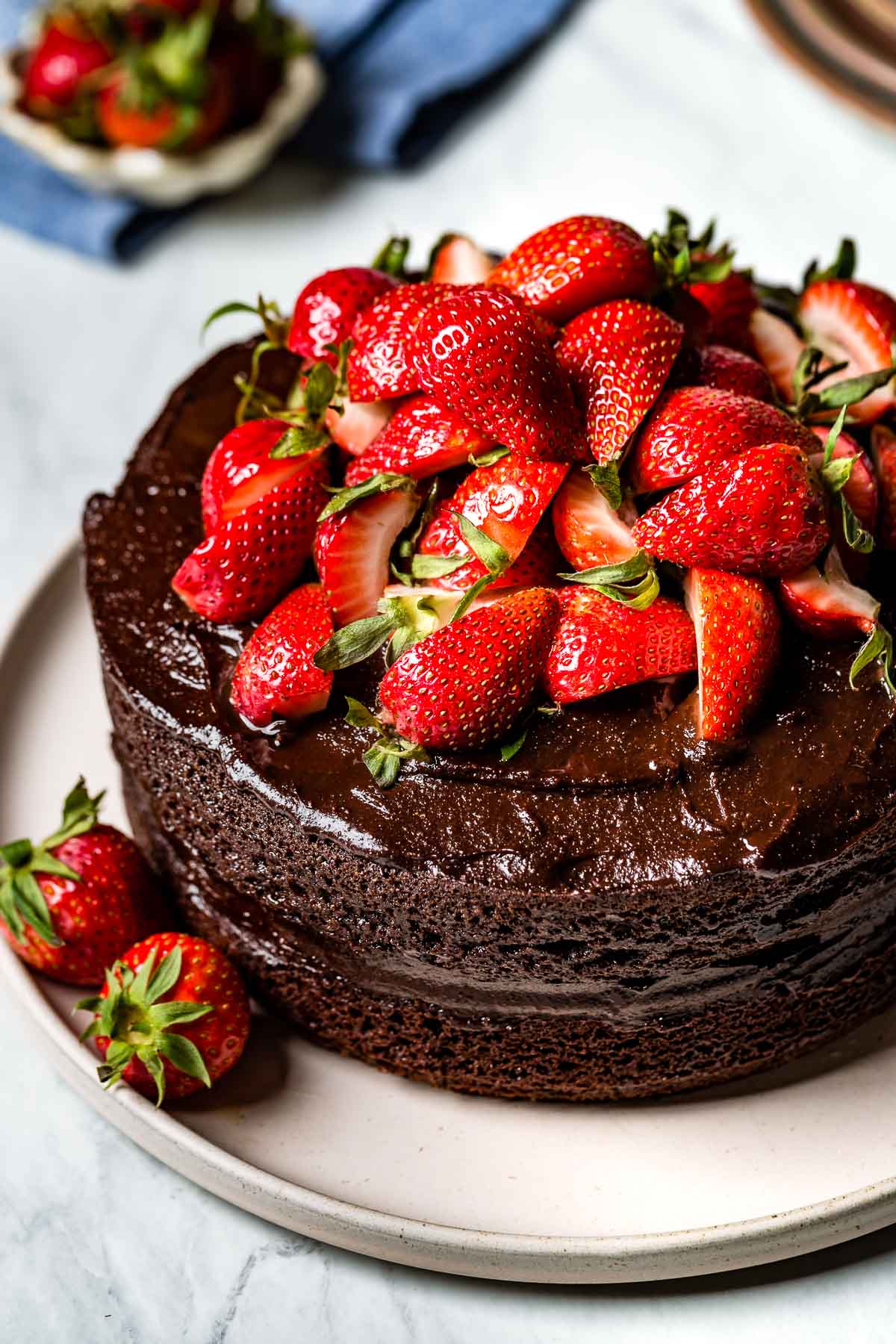 Almond Flour Chocolate Cake topped off with strawberries on a plate