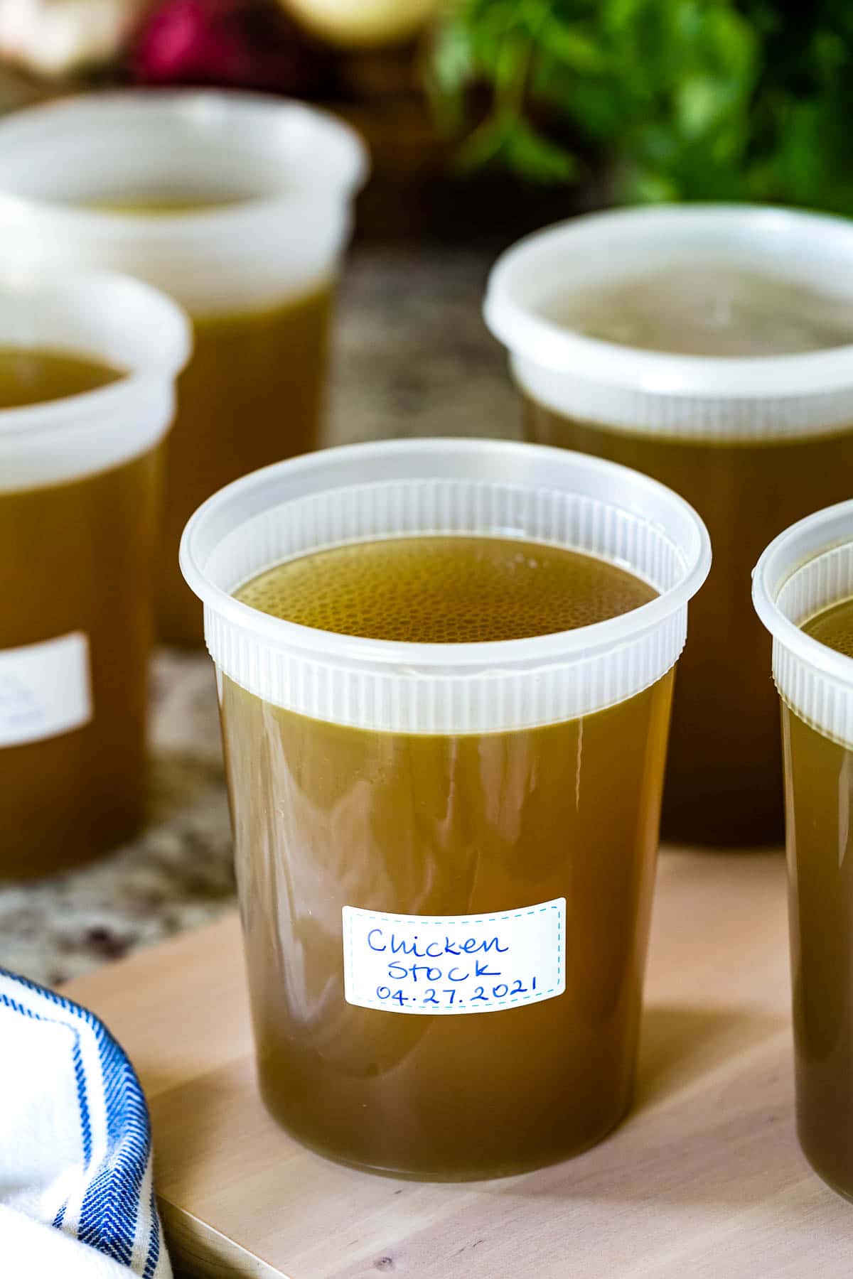 Chicken stock in freezer friendly containers cooling down on the counter