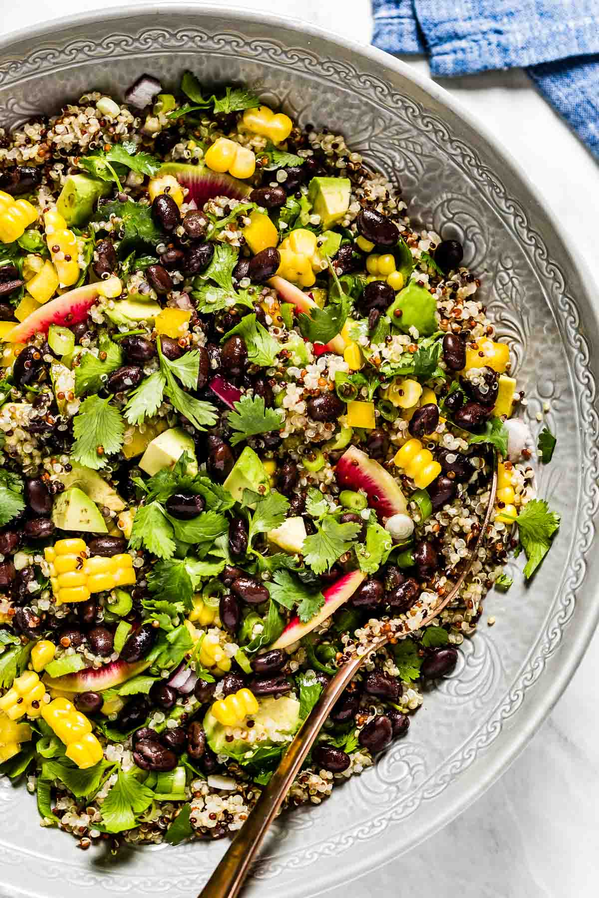 Quinoa Black Bean Salad in a bowl garnished with cilantro.