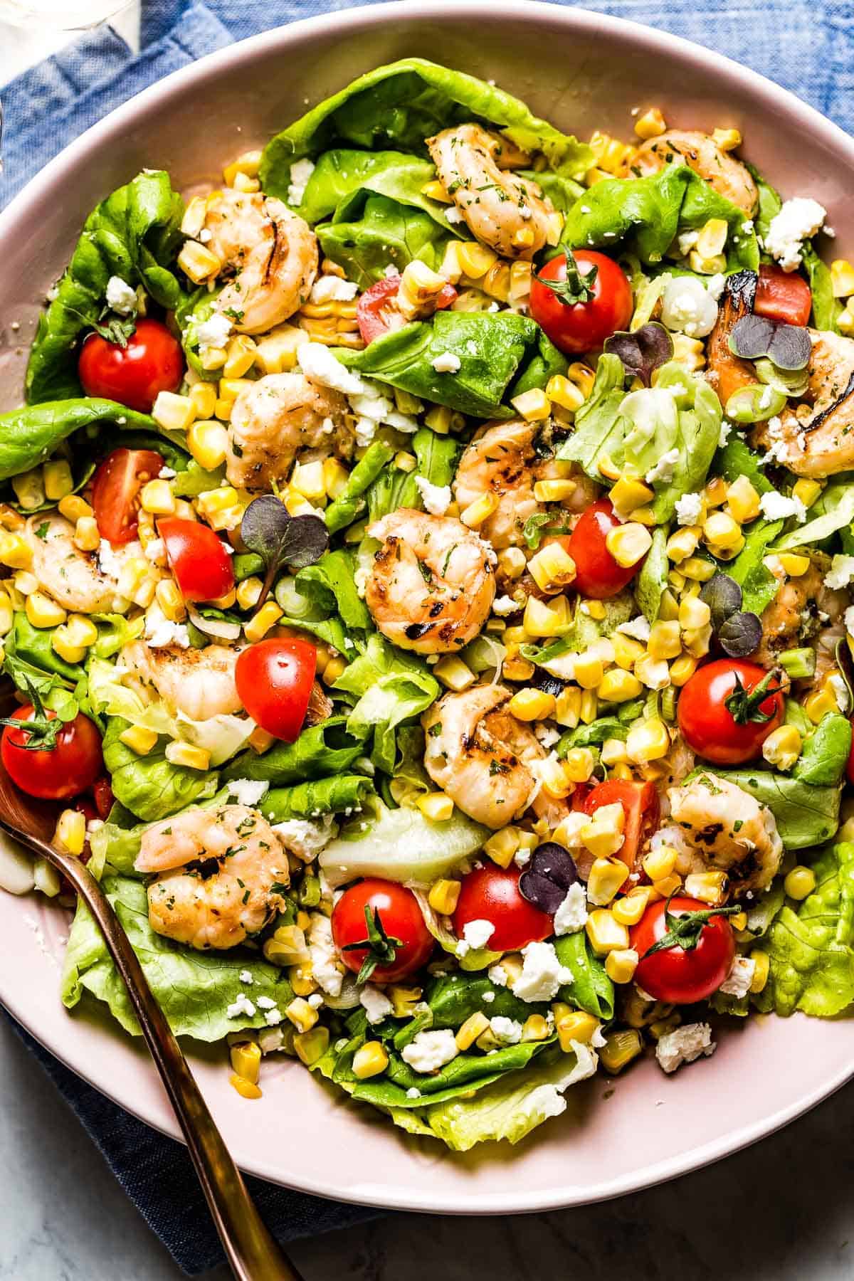 A bowl of shrimp and corn salad from the top view from a close up view