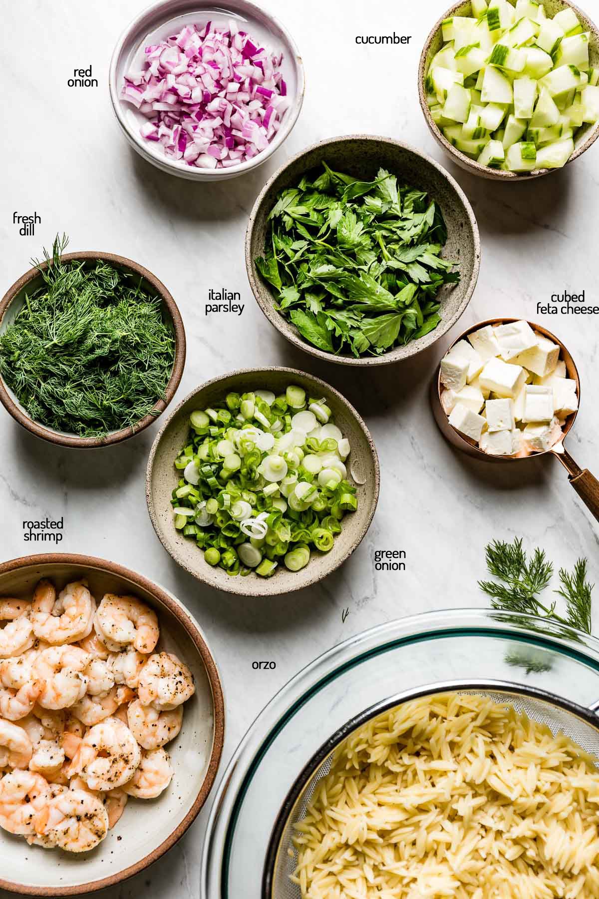 Each salad ingredient placed in small bowls from top view