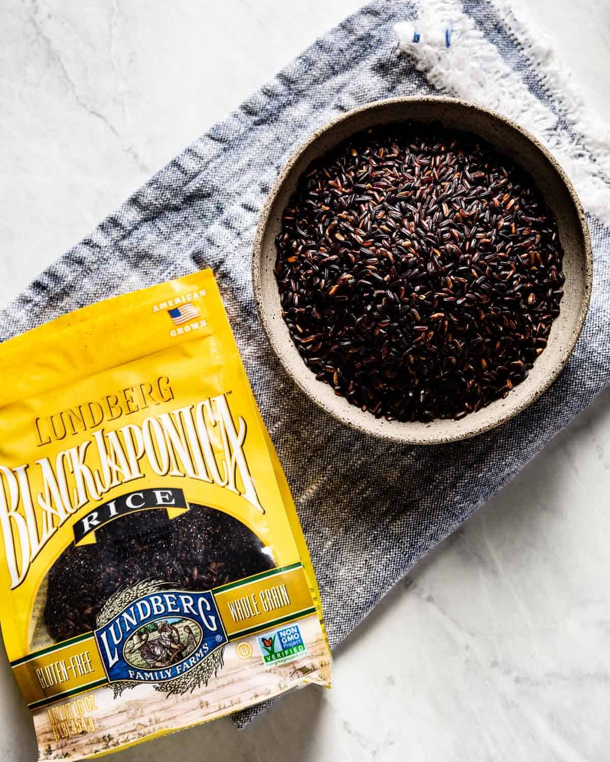 Black Japonica rice in its packaging with a bowl of it on the side