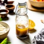 lemon balsamic dressing in a glass bottle from front view