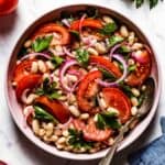 Piyaz - Turkish White Bean Salad in a bowl with a spoon on the side