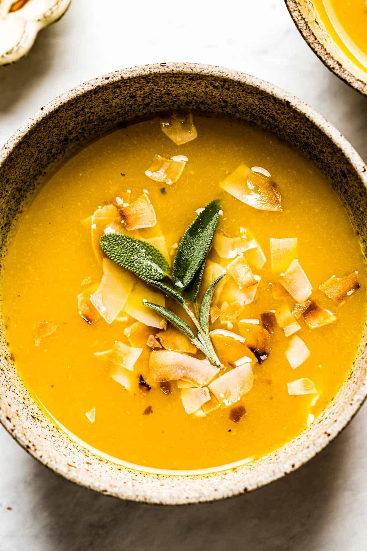 Pumpkin and Ginger Soup garnished with sage top view
