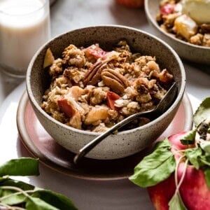 Apple crisp in a bowl with a spoon in the bowl.