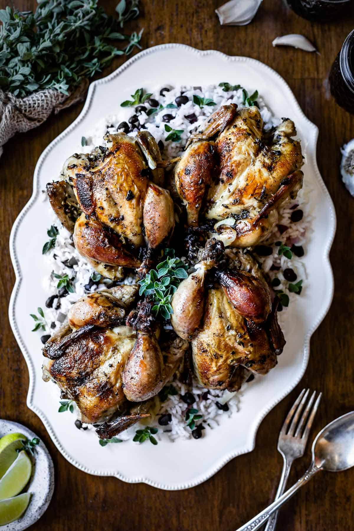 Roasted Cornish Hens placed on a large plate and photographed from the top view.