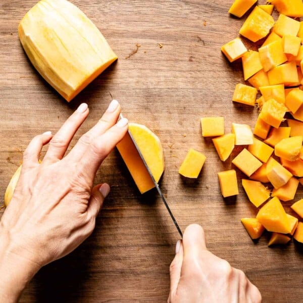 person showing how to cut butternut squash into cubes