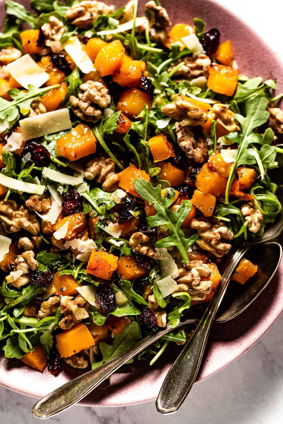 Butternut squash arugula salad in a large bowl