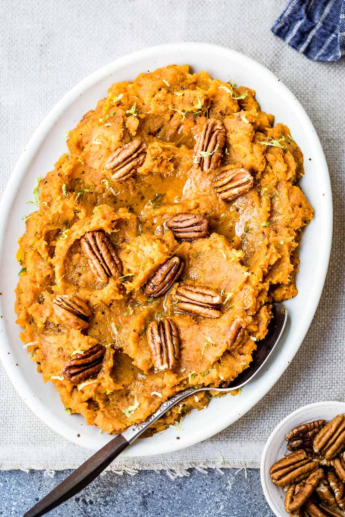 Sweet potato mash on a plate with a spoon on the side