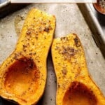 whole roasted butternut squash halves on a sheet pan with text on the image