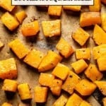 roasted butternut squash cubes on a sheet pan with text on the image