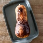 Roasted whole butternut squash fresh out of the oven on a sheet pan from the top view.