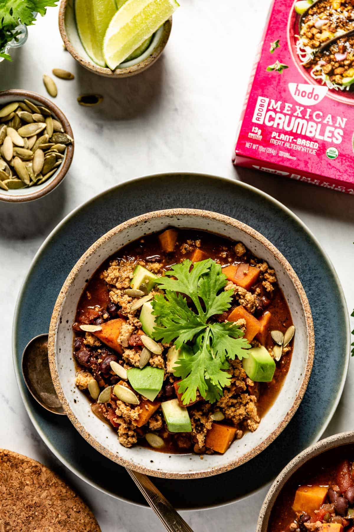 Vegan Chocolate Chili in a bowl with condiments on the side
