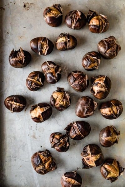 roasted chestnuts on a sheet pan from top view