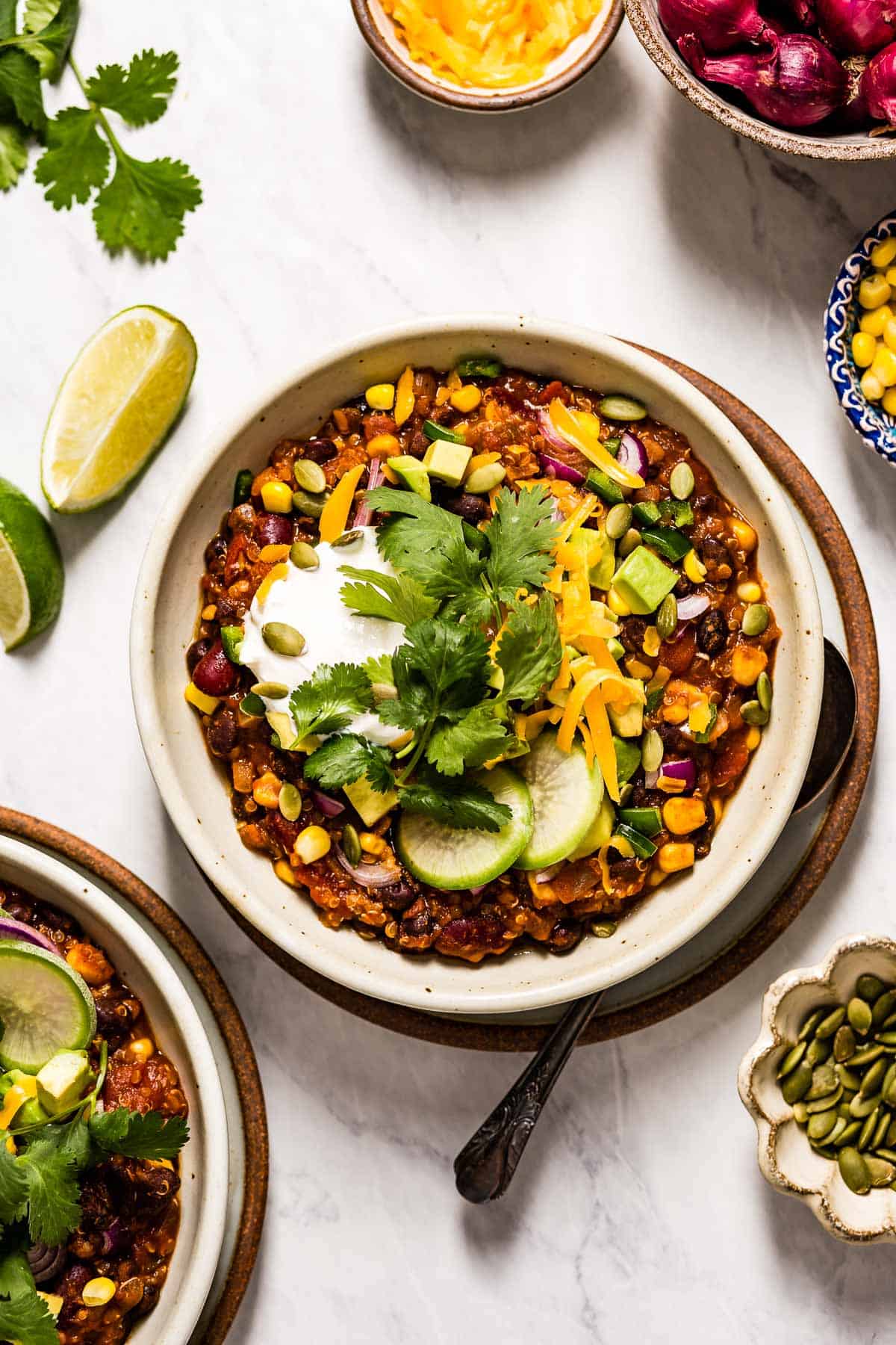 A bowl of Vegan Chili with Quinoa Recipe is photographed from the top view from a close up distance.