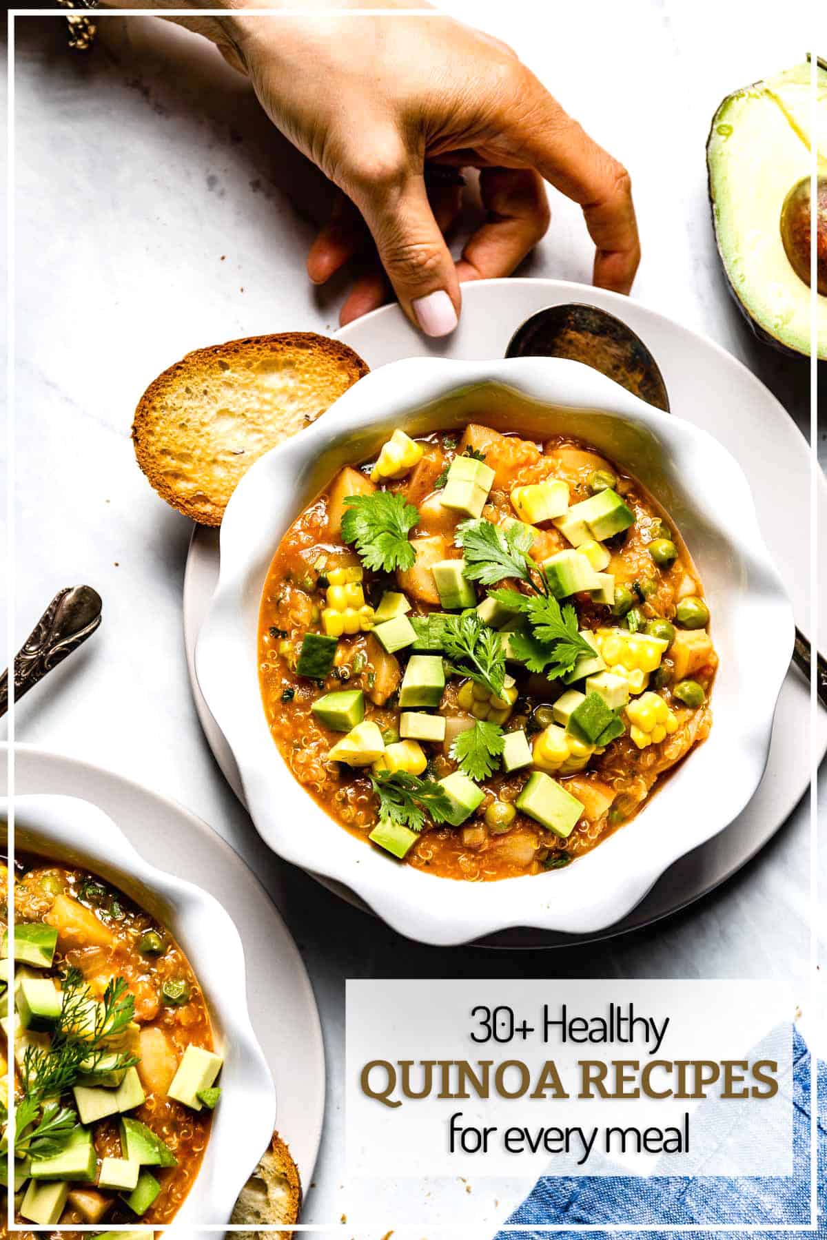 A person is placing a quinoa chili on the table with sliced bread on the side