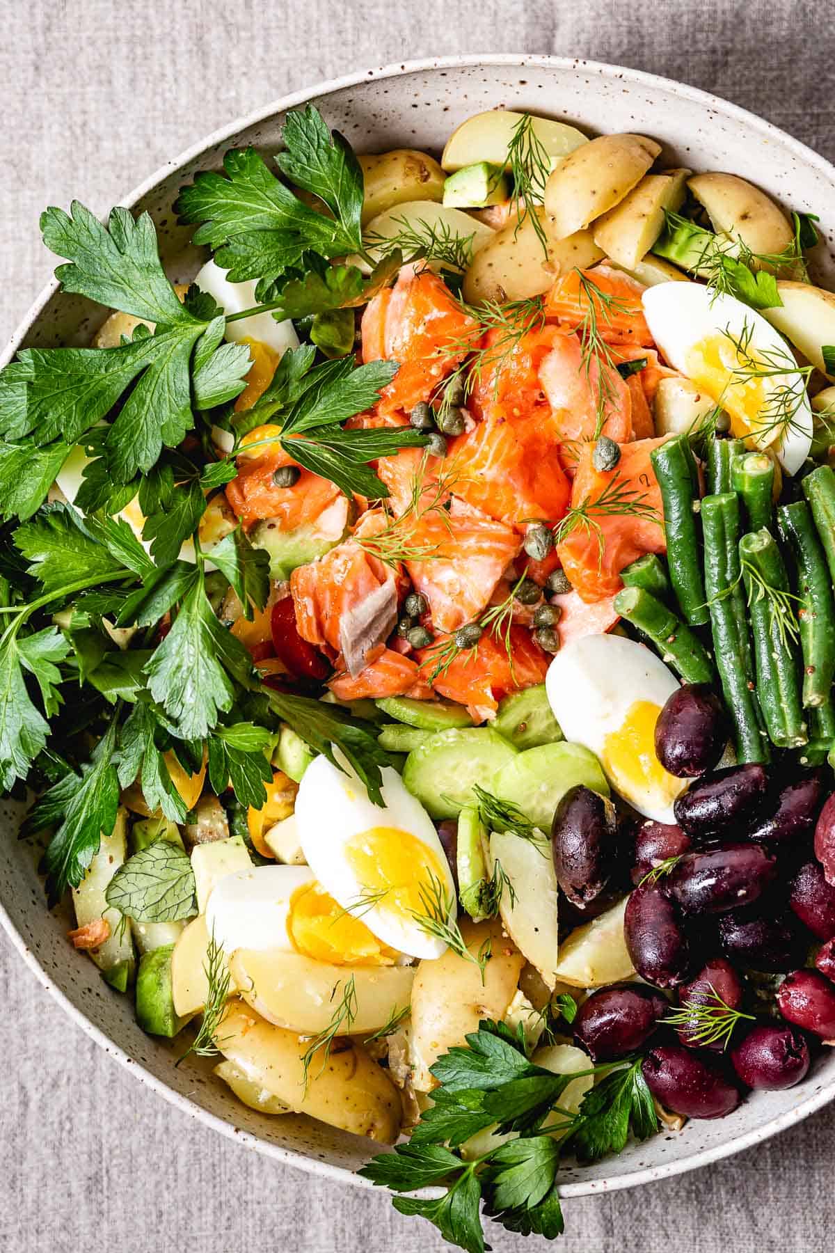 A bowl of Salmon Nicoise salad recipe from the top view