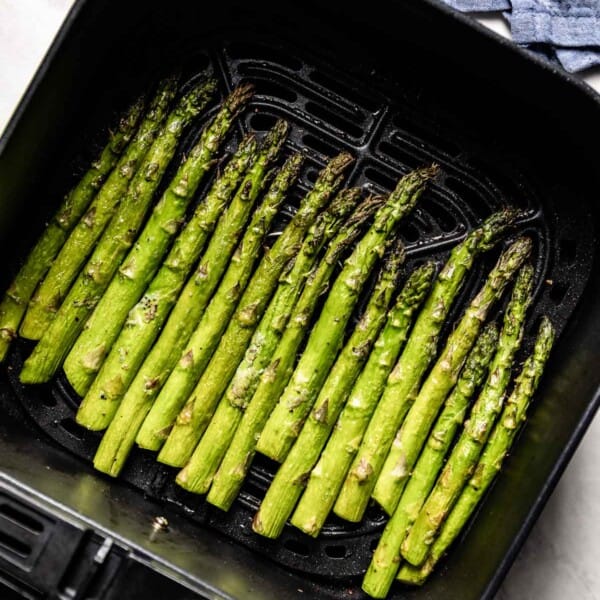 Air fryer asparagus in the basket right after it is cooked
