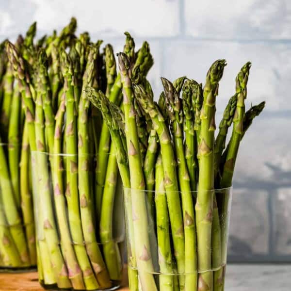 Glasses filled with water storing asparagus spears