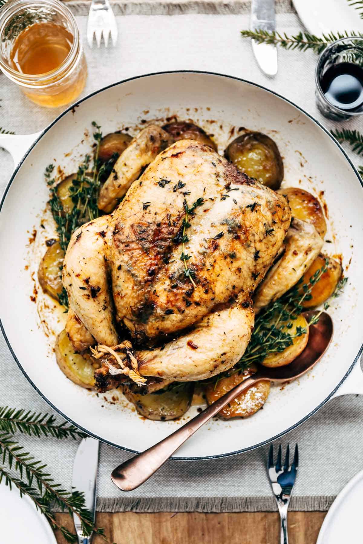One Pan Whole Roasted Chicken and Potatoes photographed in a skillet