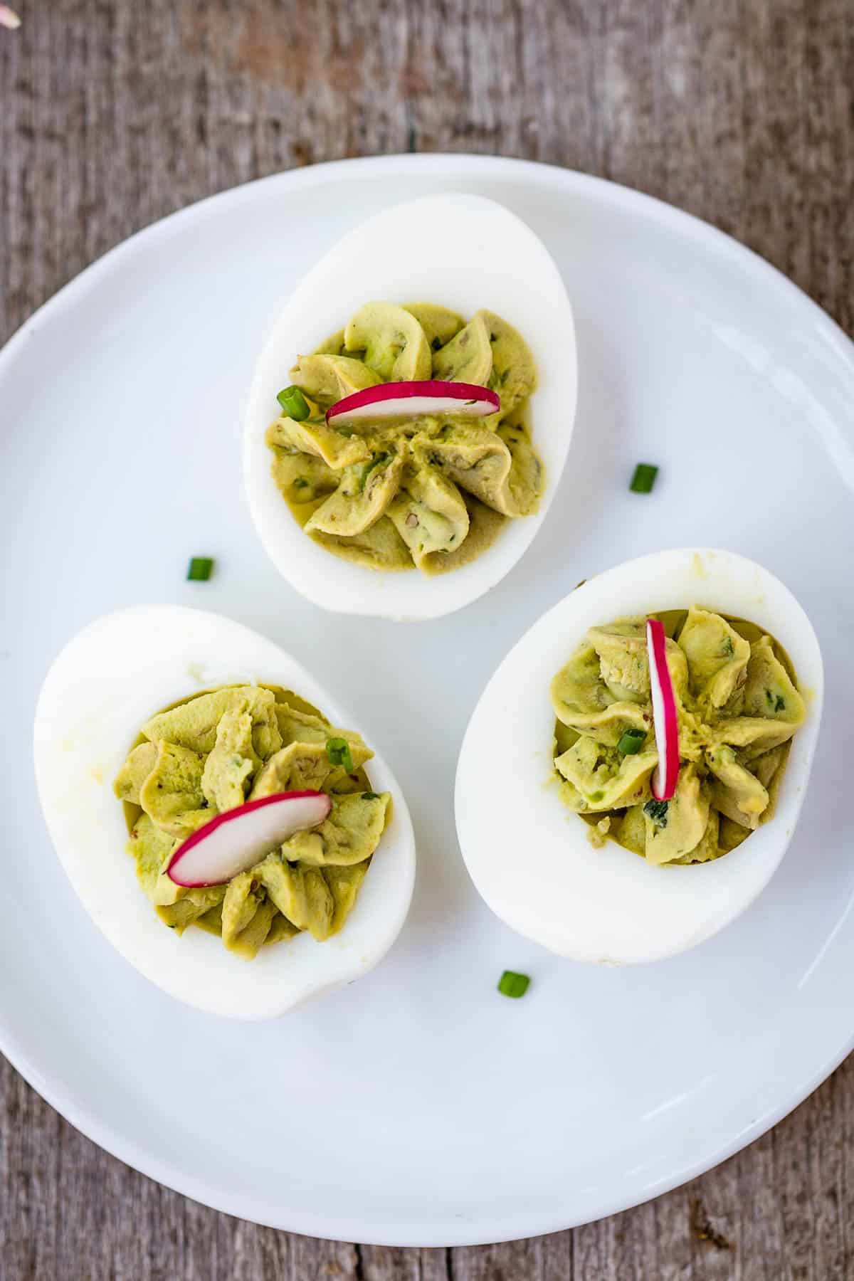A plate filled with healthy deviled eggs avocado