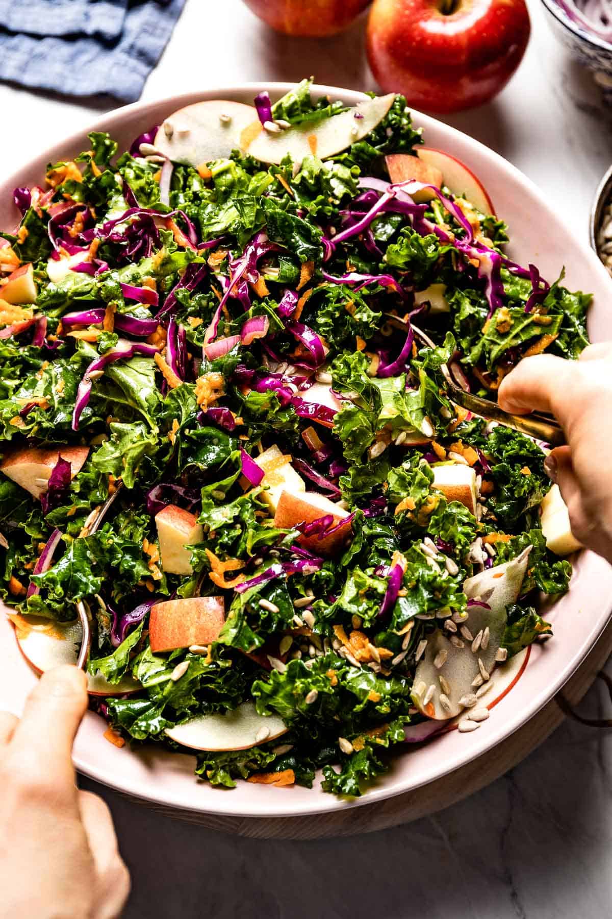 person tossing kale slaw from top view