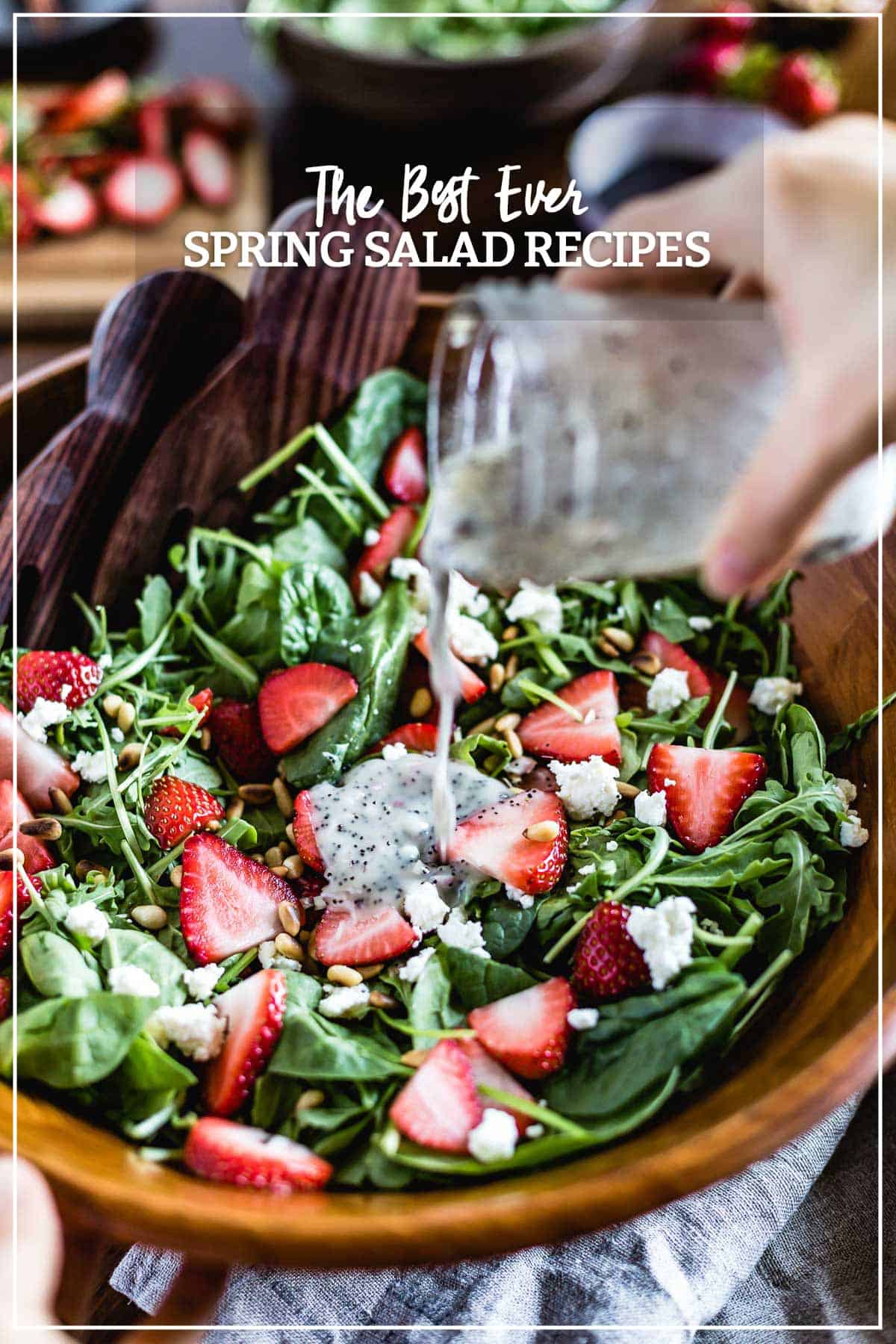 Spring salad being drizzled with dressing with text on the image.