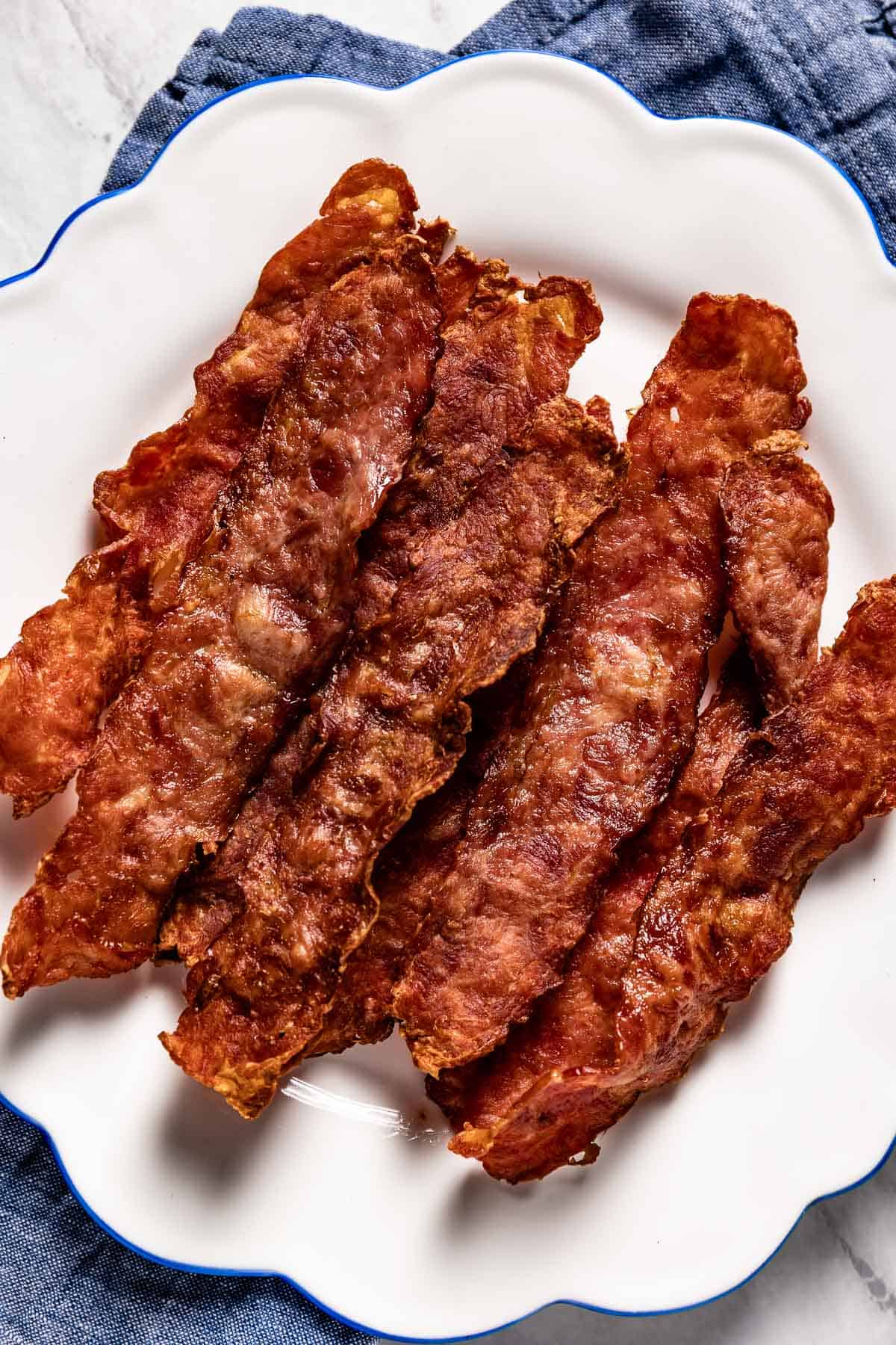 Air fried turkey bacon on a plate from the top view