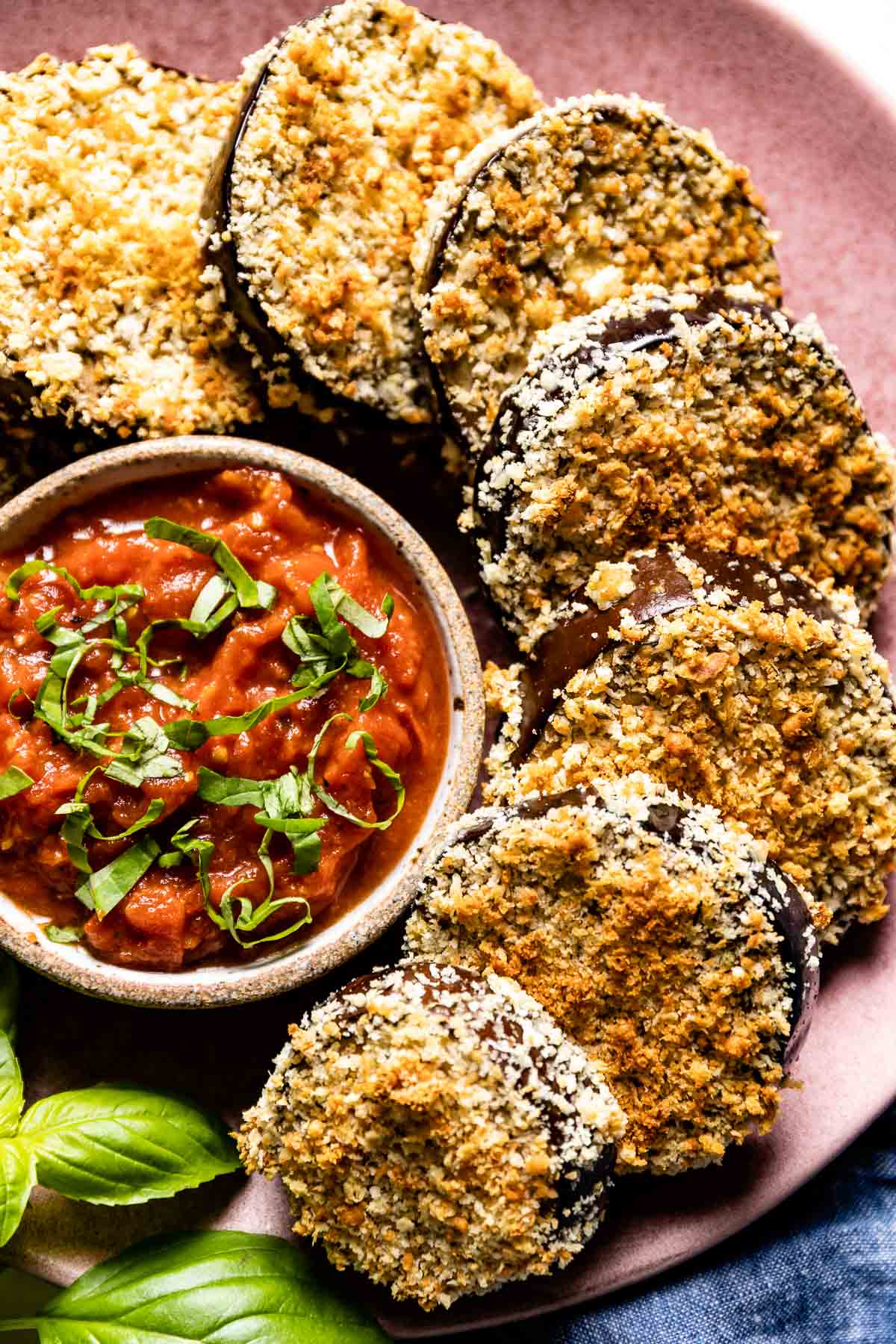 Crispy baked breaded eggplant served with tomato sauce on the side