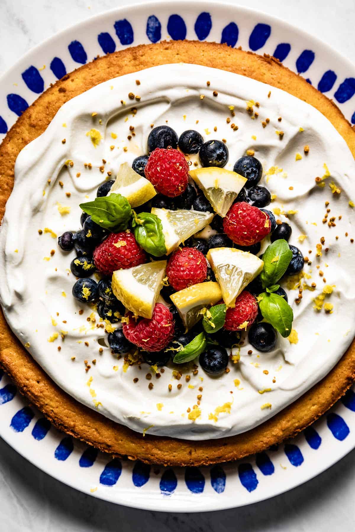 Almond Flour Lemon cake garnished with fruit from the top view