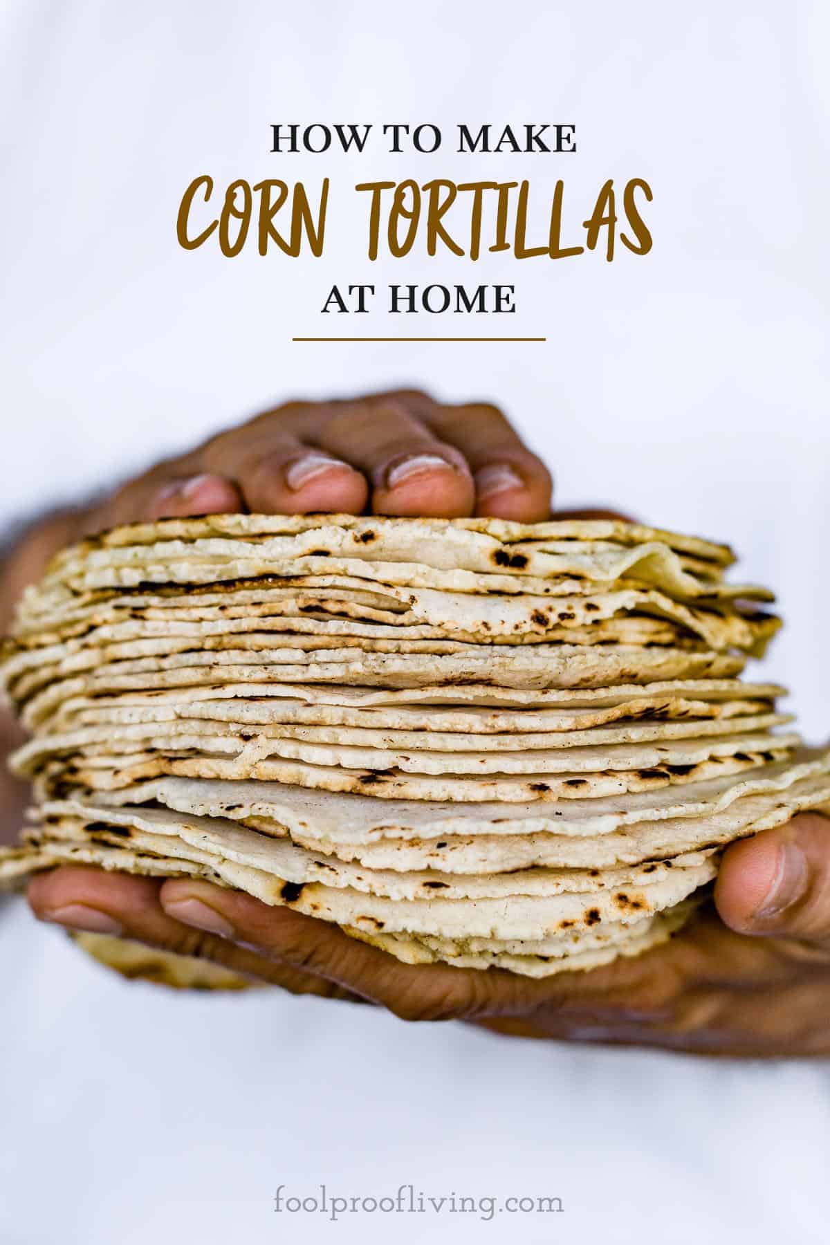 A man is serving corn tortillas placed on top of each other with text on the image