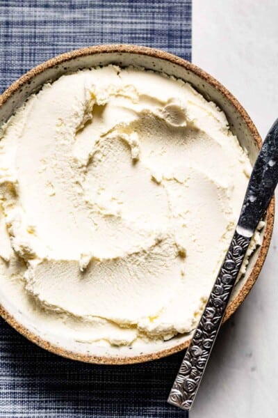 Ina Garten ricotta cheese in a bowl with a knife on the side