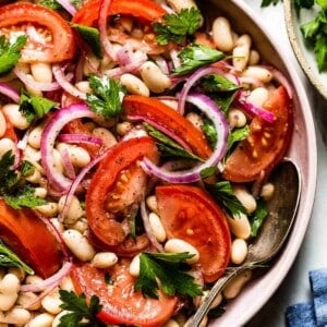Summer salad with tomatoes and white beans in a bowl.