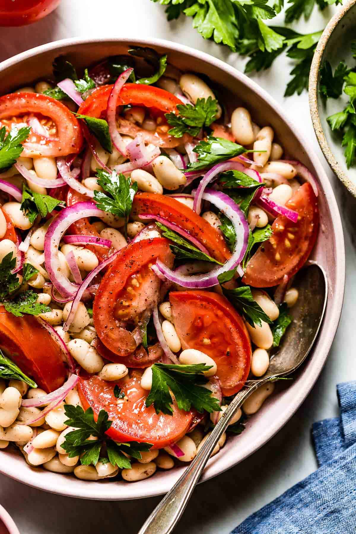 A bowl of white bean cold summer salad from the top view