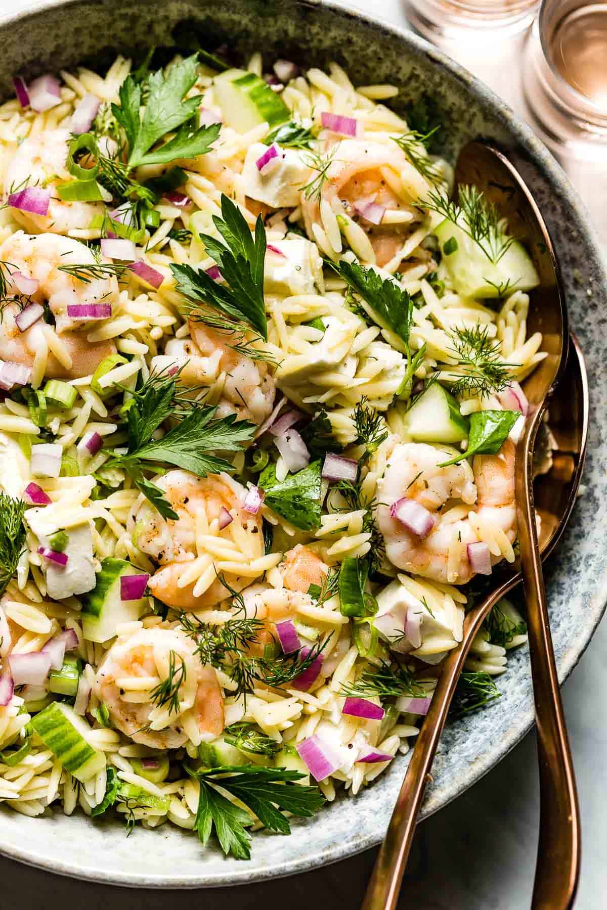 classic summertime salad made with shrimp, red onion, and orzo from the top view
